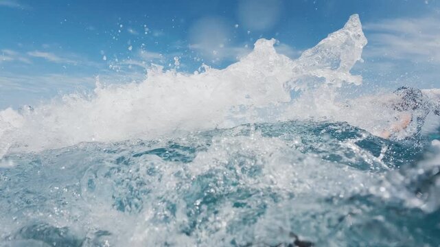 Surfer rides the wave in the ocean in the Maldives. Clip with different speed and speed warp effects