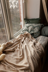 Cozy Pillows on Window Seat with Warm Lights