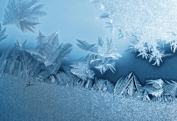 Beautiful ice pattern on window glass, close-up natural winter background