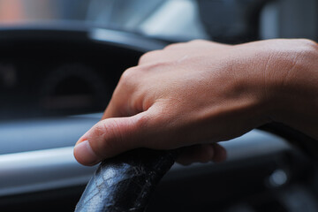 Human Hands Gripping Car Controls Close-Up
