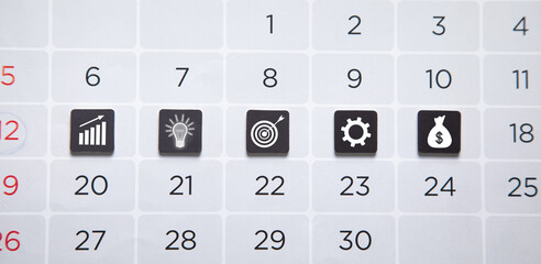 Goals and business icons on calendar.