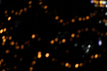 Dense multicolored bokeh Christmas lights background, chaotic texture of purple orange and white defocused circles, festive holiday night party atmosphere wallpaper or backdrop © TomKorcak