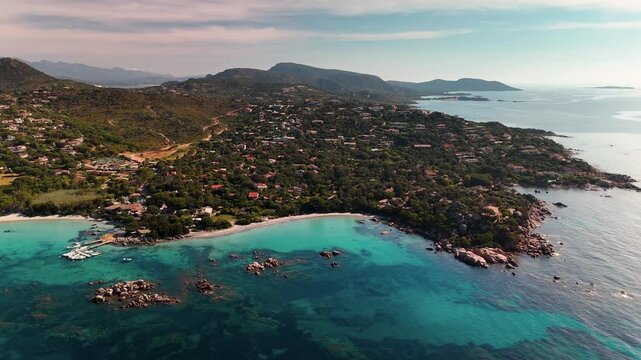 Expansive Aerial Drone Wide Shot Over the Turquoise Lagoon and White Sand Beach of Plage de Santa Giulia near Porto Vecchio, Corsica, France, on a Sunny Morning.