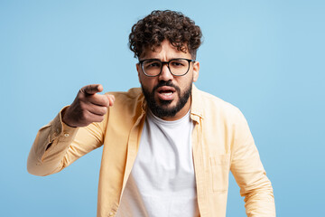 Accusation concept with man pointing index finger, blaming with angry expression