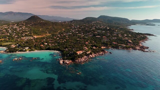 Expansive Aerial Drone Circling Shot at High Altitude Over the Plage de Santa Giulia White Sand Beach, Turquoise Lagoon, and Lush Corsican Coastline.
