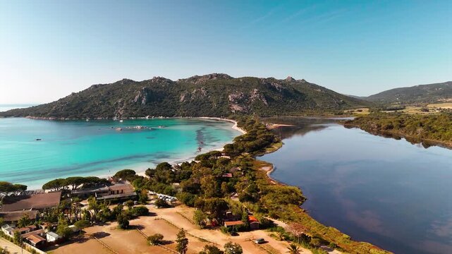 Smooth Aerial Drone Pan Out Shot Revealing Pristine Plage de Santa Giulia White Sand Beach, Turquoise Lagoon, and Lush Coastal Landscape near Porto Vecchio, Corsica.