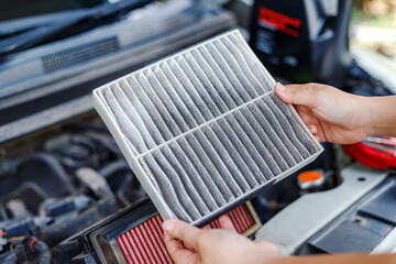 Hand of Woman Holding Dirty Cabin Air Filter