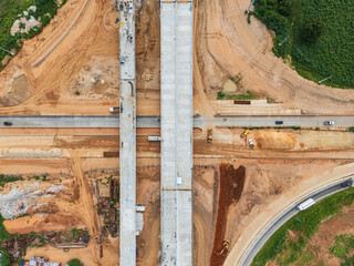 Drone shot of highway and overpass construction site with vehicles and road in a rural place