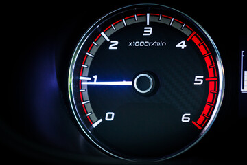 Close-up of a diesel truck's dashboard and tachometer. It represents the power and durability of a work vehicle, with a clear focus on the round engine meters.