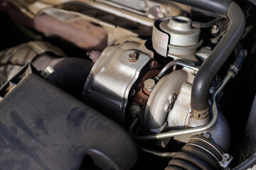 Close-up of car turbocharger system showing engine detail, metal texture, and automotive technology concept