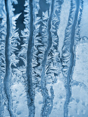 Beautiful ice pattern on window glass, close-up natural winter background