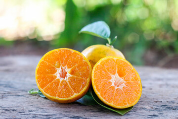 Vibrant orange slices arranged casually on old wooden surface, minimal and warm.