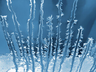 Beautiful ice pattern on window glass, close-up natural winter background