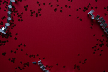 Bright red star-shaped confetti scattered across an intense purple field creates a ready-made design with perfect negative space for headlines and messages.