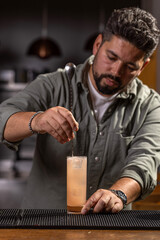 Bartender mixing ingredients