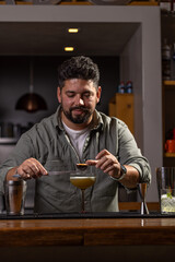 Bartender garnishing a cocktail with passion fruit