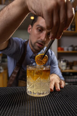 Bartender garnishing a cocktail