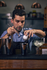 Bartender pouring ingredients