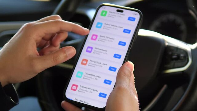 Hands of a potential customer evaluating leasing terms for different products directly from his vehicle. This footage captures the initial research phase for a significant financial decision.