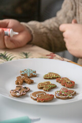 Decorated coloring gingerbread cookies in the plate