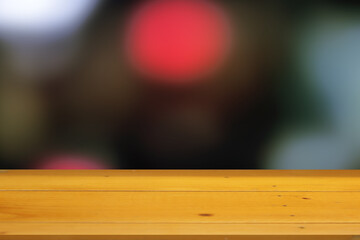 Wooden table surface with black bokeh blurred background for product placement