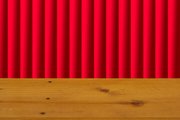 Wooden table surface separated, blurred background, red curtain stage