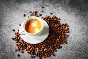 Coffee cup and coffee beans on gray background, Espresso crema coffee cup aromatic, top view