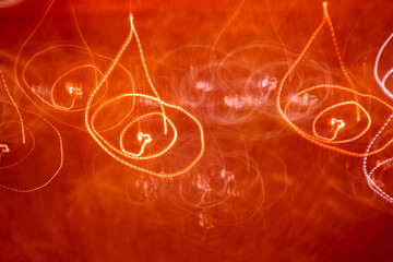 Abstract red light painting with circular motion. Creative neon loops and scribbles background for party or music design.