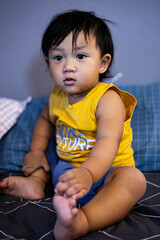 Toddler Waits Quietly On Bed