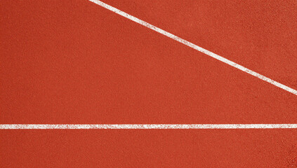 Close up of a running track with a white line.