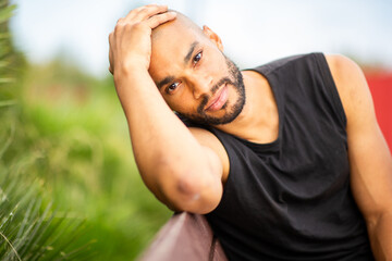 Relaxed young man with beard leaning head on hand
