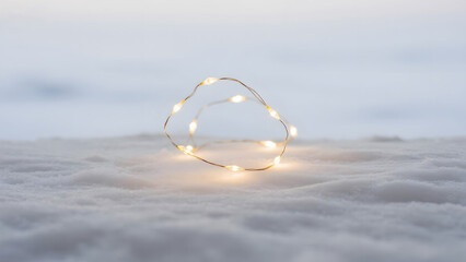 Festive String Lights, Heart Shape, Snowy Background, Holiday Decor, Winter Scenery, Warm Glow, Romantic Ambiance