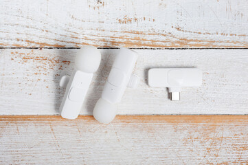 Two wireless microphones and a transmitter for your phone.