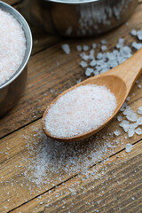 Pink Himalayan Salt in Wooden Spoon on Rustic Wooden Surface