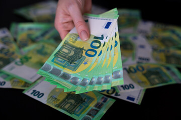 Euro bills in female hands Euro cash background banknotes fan one hundred euros