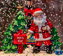 Santa Claus Mailing Gifts in Festive Snowy Christmas Scene with Decorated Trees and Santa Mailbox. New Year Background 
