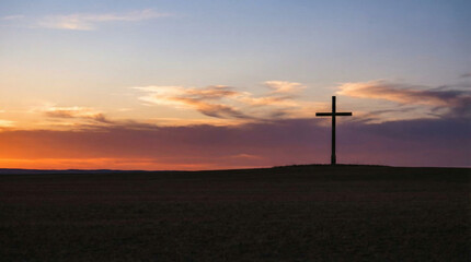 Obraz premium Cross on open field at sunset — peaceful Christian silhouette landscape