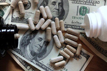 Natural supplements industry. Ashwagandha pills over american bills. Lion&acute;s mane capsule bottle. 