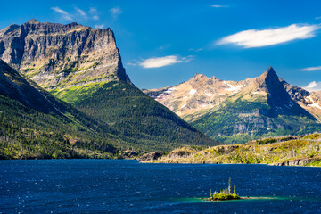 Wild Goose Island sits in blue waters of Saint Mary Lake in Glacier National Park, Montana, USA. Scenic landscape features majestic peaks and pine trees in UNESCO World Heritage site