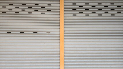 Rolling door. Steel shutter door of warehouse. The shutters are gray metal. Steel rolling shutter background. Silver metal rolling shutter background. Background images and texture images.