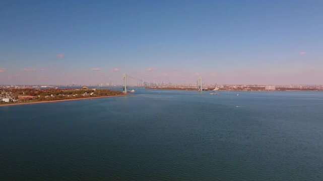 Aerial drone view of Hoffman Island in New York Harbor, a small historic island surrounded by calm open water with the distant coastline visible on the horizon.