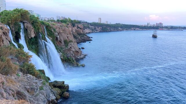 View of the Nizhny Duden waterfalls in Antalya, Turkey. Waterfalls fall from a rocky cliff into the Mediterranean Sea. The cascade is formed by the Duden River, one of the rivers in southern Anatolia.