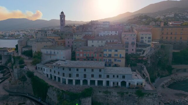 picturesque harbor during twilight hours, historic fortress overlooks tranquil water at evening. Bastia. France