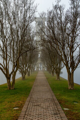 Clock tower on a lake on a foggy morning