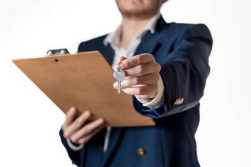 Close-up of Real Estate Agent Offering Key and Holding Clipboard