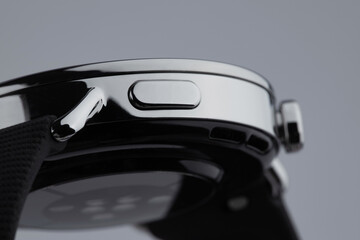 Close-up of a sleek smartwatch side with buttons and sensors