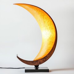 A desk lamp with an elongated, curved body and an amber light shade on the top that resembles rice paper in shape.