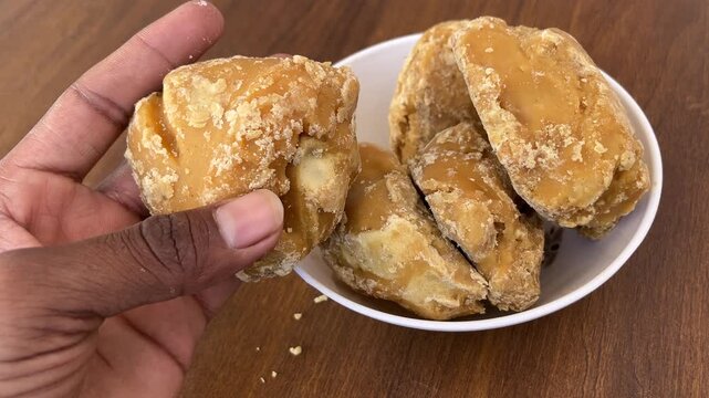Bowl Holding Jaggery Pieces Close Up 4K Vertical Footage