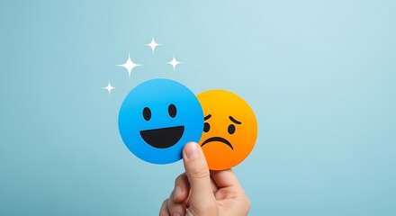 Hand holding happy and sad emoji faces against a light blue background symbolizing mood change and choice
