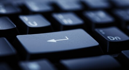 Keyboard enter key close-up with shallow depth of field and cool lighting